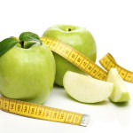 Healthy green apple and a measuring tape